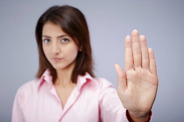 istock Young woman holding up her left hand to stop someone 470551781