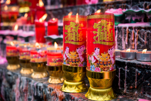 Chongqing, People’s Republic of China - October 19, 2013: Chinese people worship their Gods with incenses, candles, oil lamps, and food at the temples in Chongqing, Sichuan, China, for their feasts as they belief that will bring happiness, long lives, and prosperities.