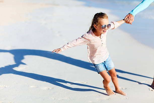 istock Adorable little girl at beach 470552291