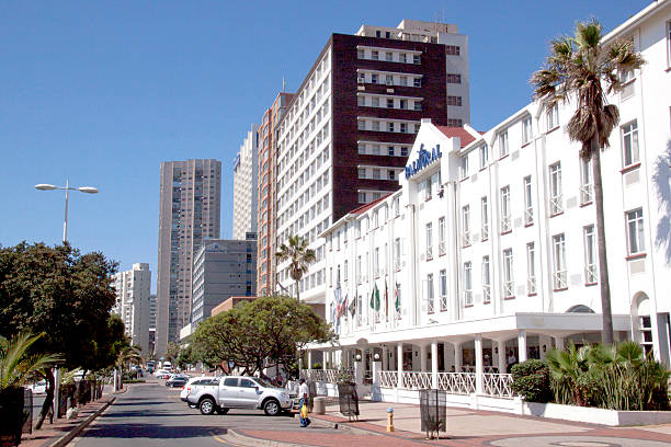 Durban, South Africa - February 8, 2014: Hotels and residences, pedestrians and  vehicles parked along the\