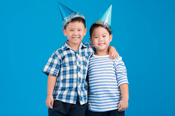 two boys celebrate birthday isolated on white