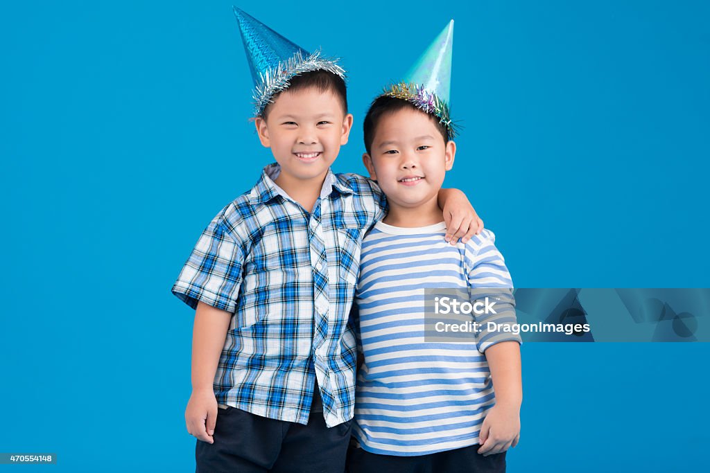 Friends in party hats Portrait of two hugging friends in party hats Child Stock Photo