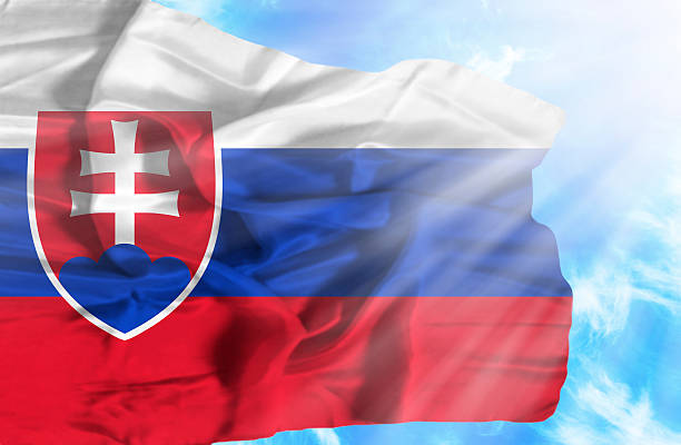 istock Slovakia waving flag against blue sky with sunrays 470555993