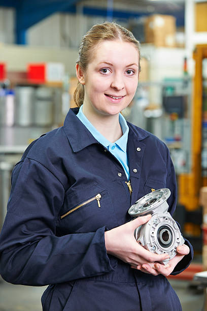 istock Portrait Of Female Apprentice Holding Component 470556195