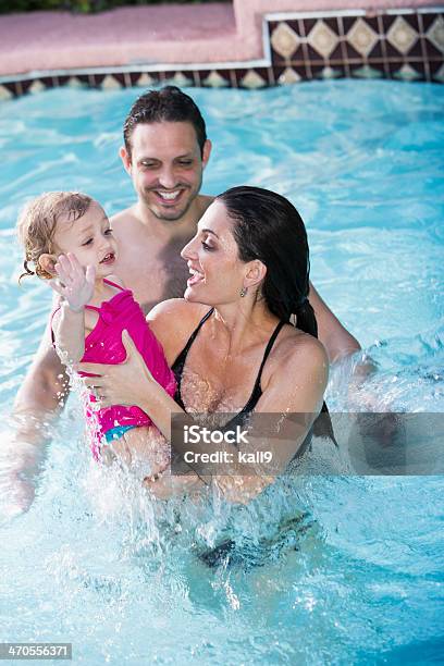 Hispanic Family In Swimming Pool Stock Photo - Download Image Now - Splashing, Young Family, 18-23 Months