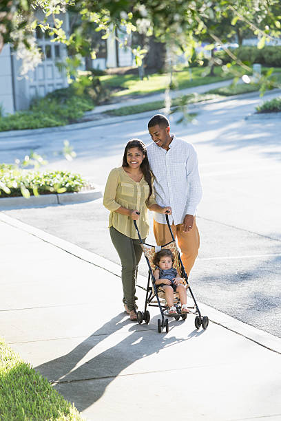 istock Young family with baby in stroller 470556483