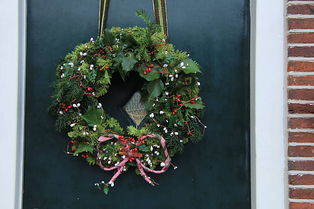 istock Classic christmas wreath with decorations on a door 470557212