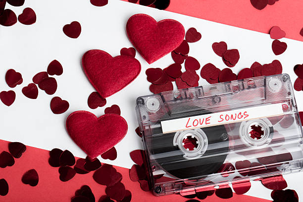 istock Audio cassette tape on red backgound with fabric heart 470559908