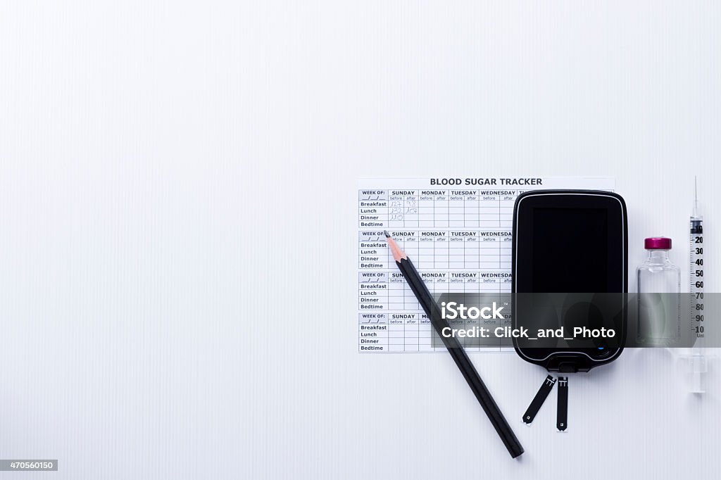 control of the diabetes top view of a diabetes control set background consisting of: a syringe, an insulin vial, a glucometer, test strips, a blood glucose diary and a pen on a white background - suitable as a copy space 2015 Stock Photo