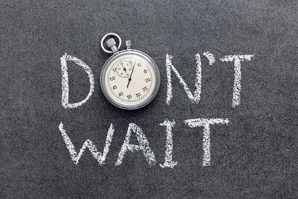 don’t wait don’t wait phrase handwritten on chalkboard with vintage precise stopwatch used instead of O delayed sign photos stock pictures, royalty-free photos & images