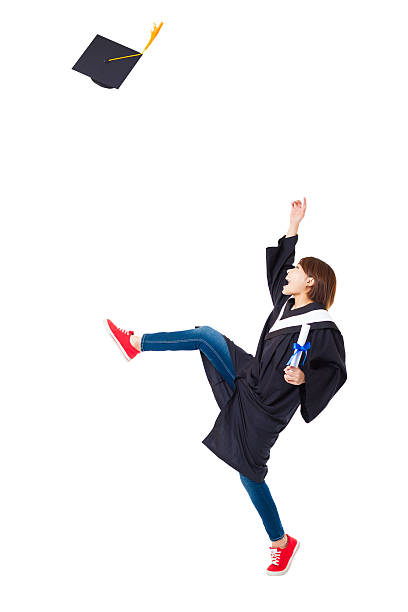 istock Happy female student in graduate robe dancing 470560858