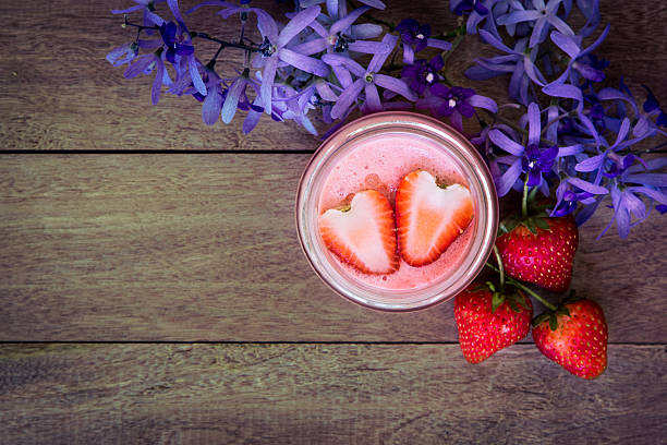 Top view of strawberry juice blended on wooden table