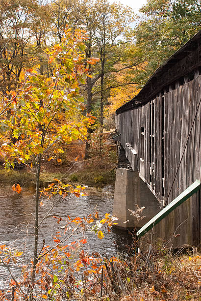 istock Fall colors and Scott Covered Bridge Vermont 470575387