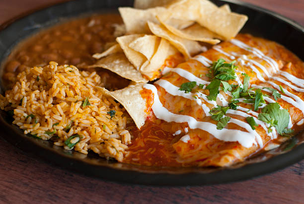 Enchiladas Delicious plateful of Enchiladas smothered in sauce and cheese. enchilada stock pictures, royalty-free photos & images