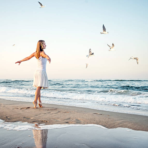 istock Girl standing at the beach 470578696