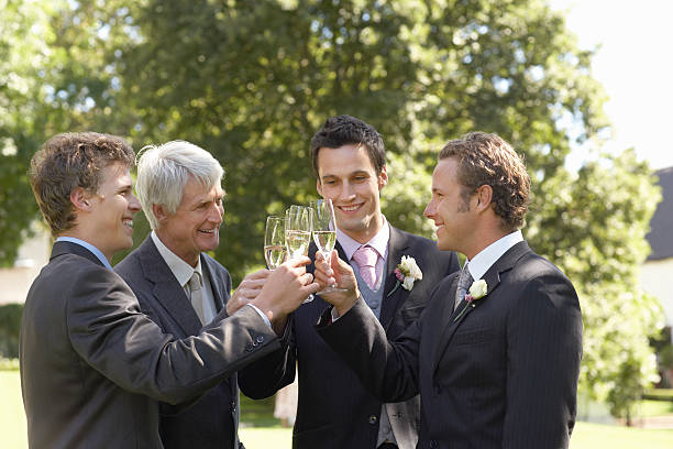 istock Men Toasting Champagne Flutes At Wedding 470580899