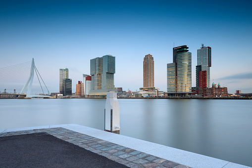 Rotterdam, Netherlands - February 27, 2015: modern buildings at Rotterdam's Kop van Zuid with the head office of the Port of Rotterdam, Hotel New York and the recently finished De Rotterdam by Dutch architect Rem Koolhaas.