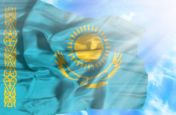 istock Kazakhstan waving flag against blue sky with sunrays 470582617