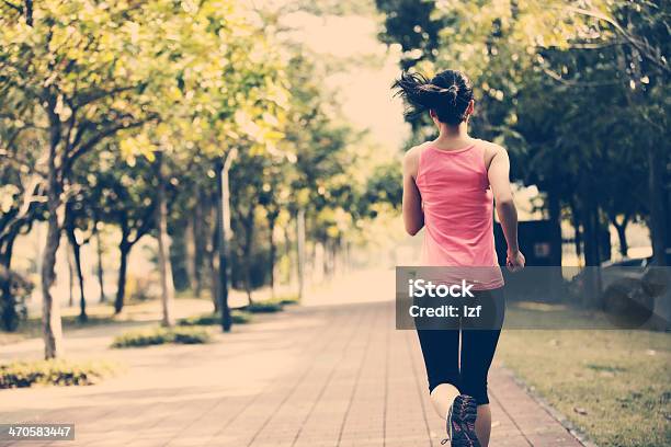 Woman Jogging At Park Stock Photo - Download Image Now - Active Lifestyle, Activity, Adult
