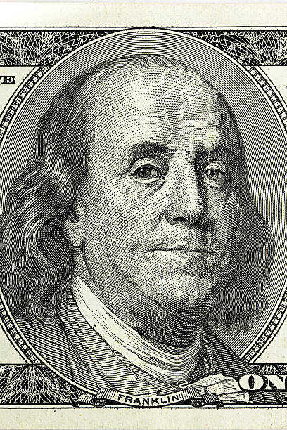 istock Benjamin Franklin. Hundred dollar bill close-up fragment 470591506
