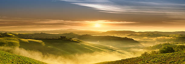Idyllic landscape - Sunrise over green fields of Tuscany stock photo