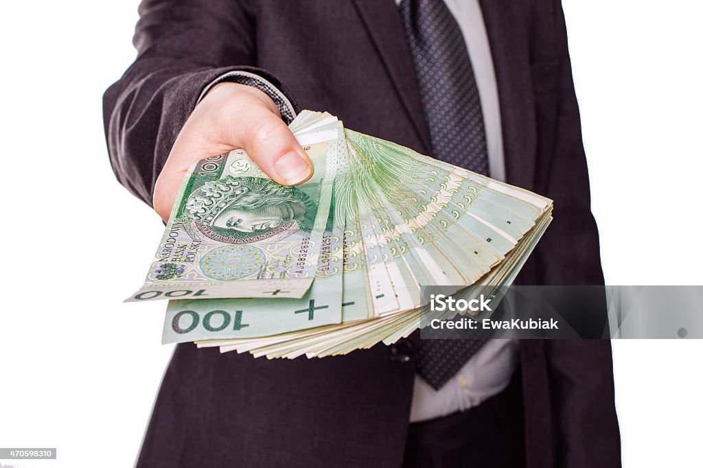 Employeer giving money The businesman holding money, perhaps employeer. 2015 Stock Photo