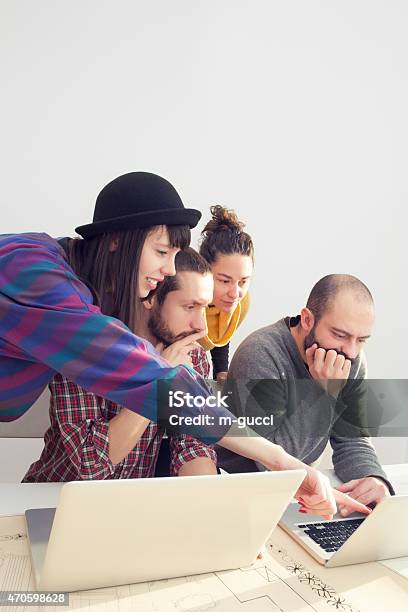 Young Group Of People Architects Discussing Business Plans Stock Photo - Download Image Now