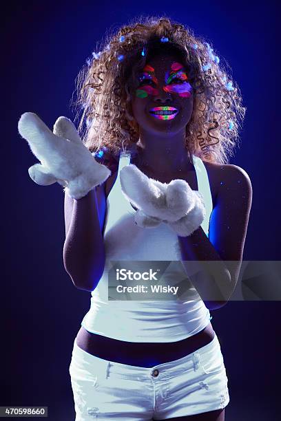 Girl Posing With Artificial Snow Under Uv Light Stock Photo - Download Image Now - 2015, Adult, Beautiful People