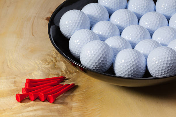istock Black ceramic bowl full of white golf balls 470598916