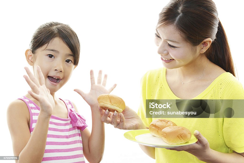 Mother and child eating food together Mother and child eating food together isolated on white background Adult Stock Photo