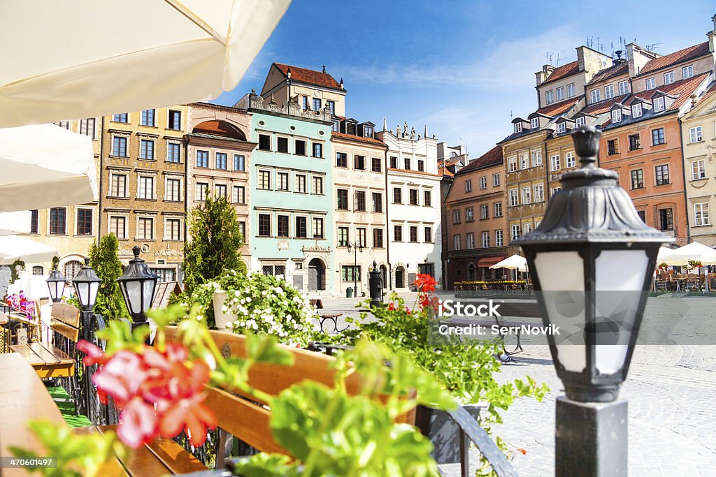 Calm old town square in Warsaw Warsaw old town marketplace square, street lamp in cafe and flowers on foreground Warsaw Stock Photo