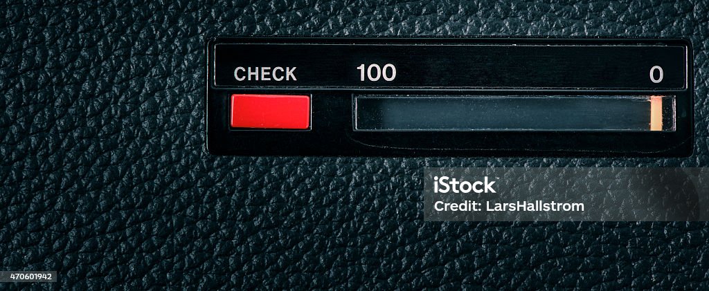 Retro technology meter with scale from 0 to 100 Close up of red check button on old retro technology equipment and scale with the numbers 0 and 100. Can be used as a conceptual image of classic old technology, testing or market research. There is only a closeup of the object in the picture, no people are present. 2015 Stock Photo
