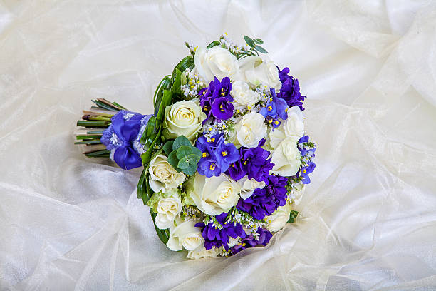 istock Wedding bouquet of the bride against a white fabric 470603184