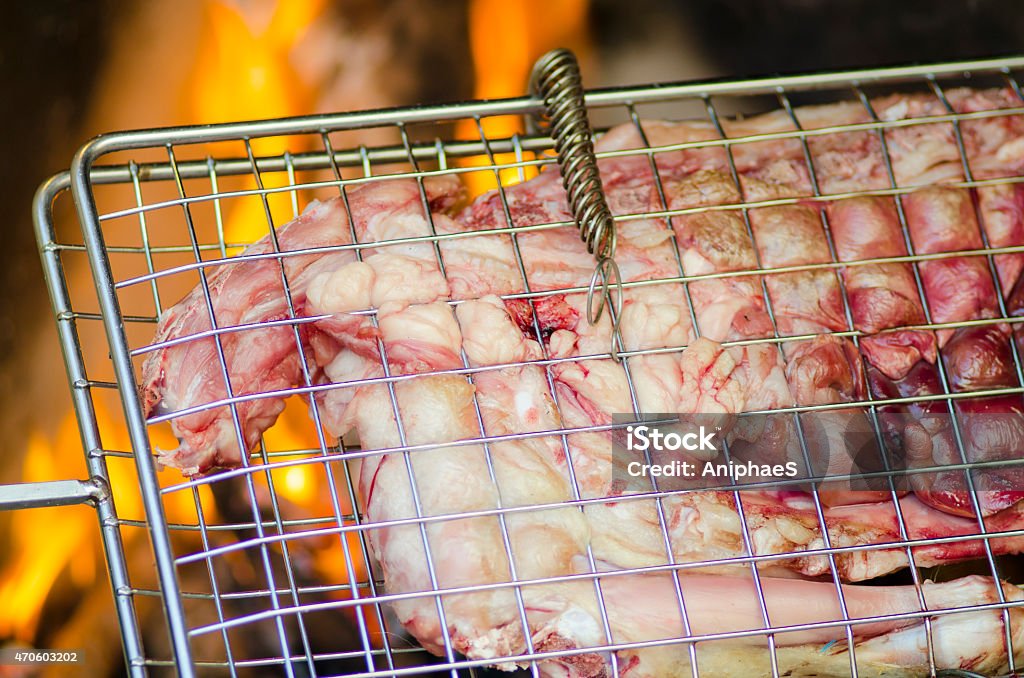 Grill with meat for barbecue fire in background Grill with meat for barbecue and fire in background for dinner 2015 Stock Photo