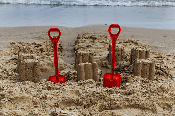 sandcastles and spades on the beach, courtown, wexford, ireland stock photo