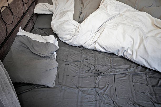 istock Disheveled sheets and pillows of an unmade bed 470606474