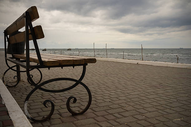 istock Empty bench on the promenade in cloudy weather 470606568