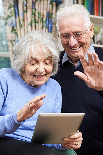istock Senior Couple Using Digital Tablet For Video Call With Family 470607150