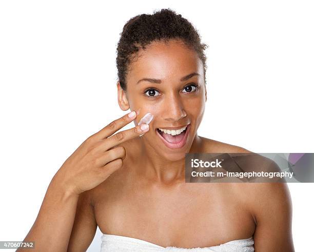 Smiling African American Woman Applying Lotion On Skin Stock Photo - Download Image Now