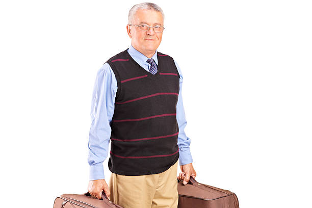 istock Smiling senior gentleman carrying two bags and looking at camera 470607252