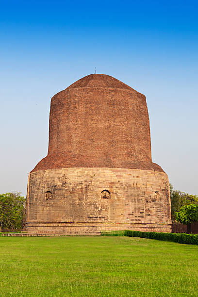 Dhamekh Stupa Dhamekh Stupa on green grass in Sarnath, IndiaDhamekh Stupa and ruins in Sarnath, India sarnath stock pictures, royalty-free photos & images