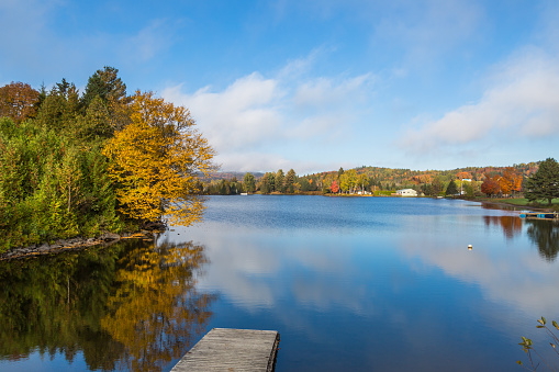 Autumn view from US highway 2 onto the lower narrows of Joes Pond in Vermont, USA.
