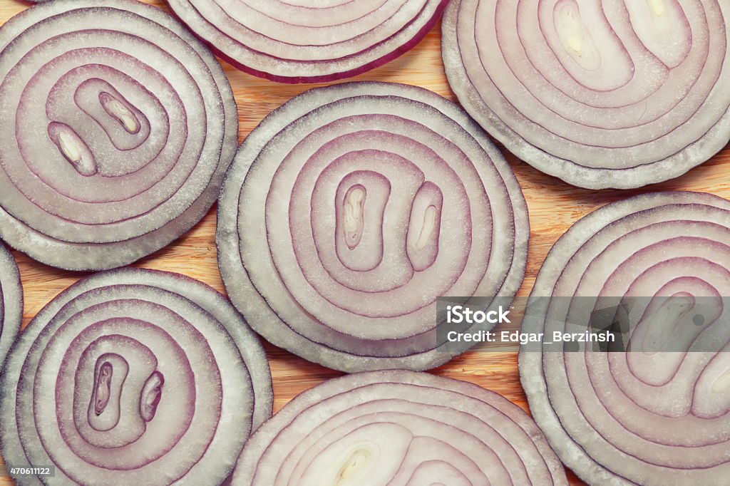 Purple onion rings on wooden cutting table 2015 Stock Photo