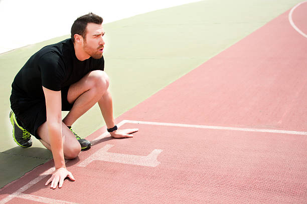 istock man ready to run on the running track 470611270