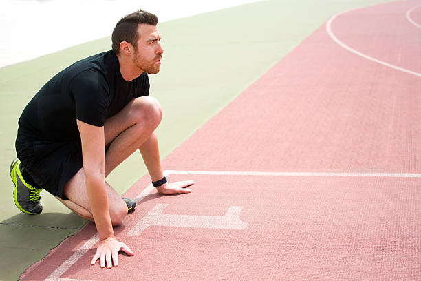 istock man ready to run on the running track 470611282