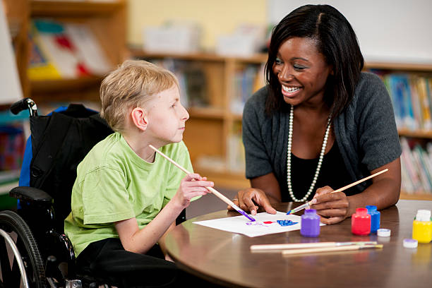 istock Special Needs Boy Painting with Teacher 470615846