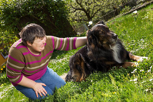 istock disabled woman on a lawn with dog 470615874