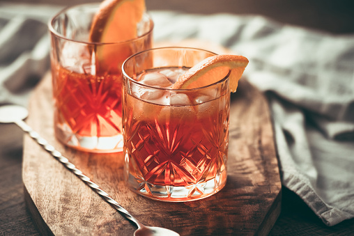 Two glasses of cocktail with orange slice. Toned image