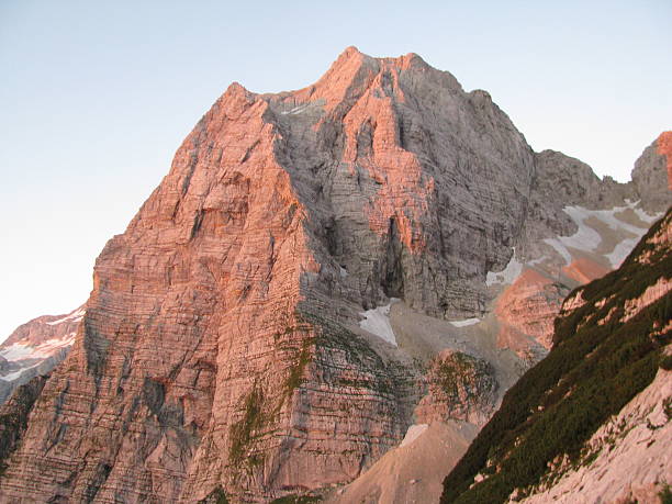 Dawn and red morning sun light on mountain's wall