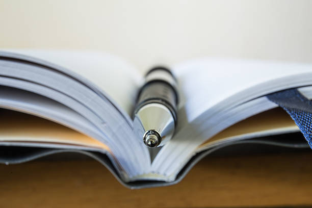 istock Close-up of open notebook and pen 470617616